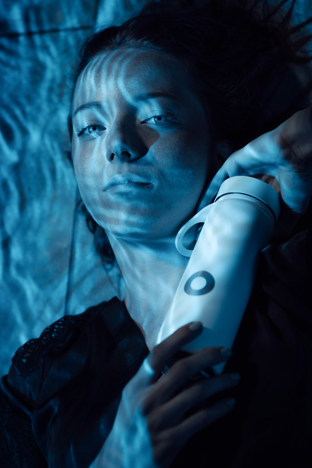 a woman holding a hair dryer in her hand