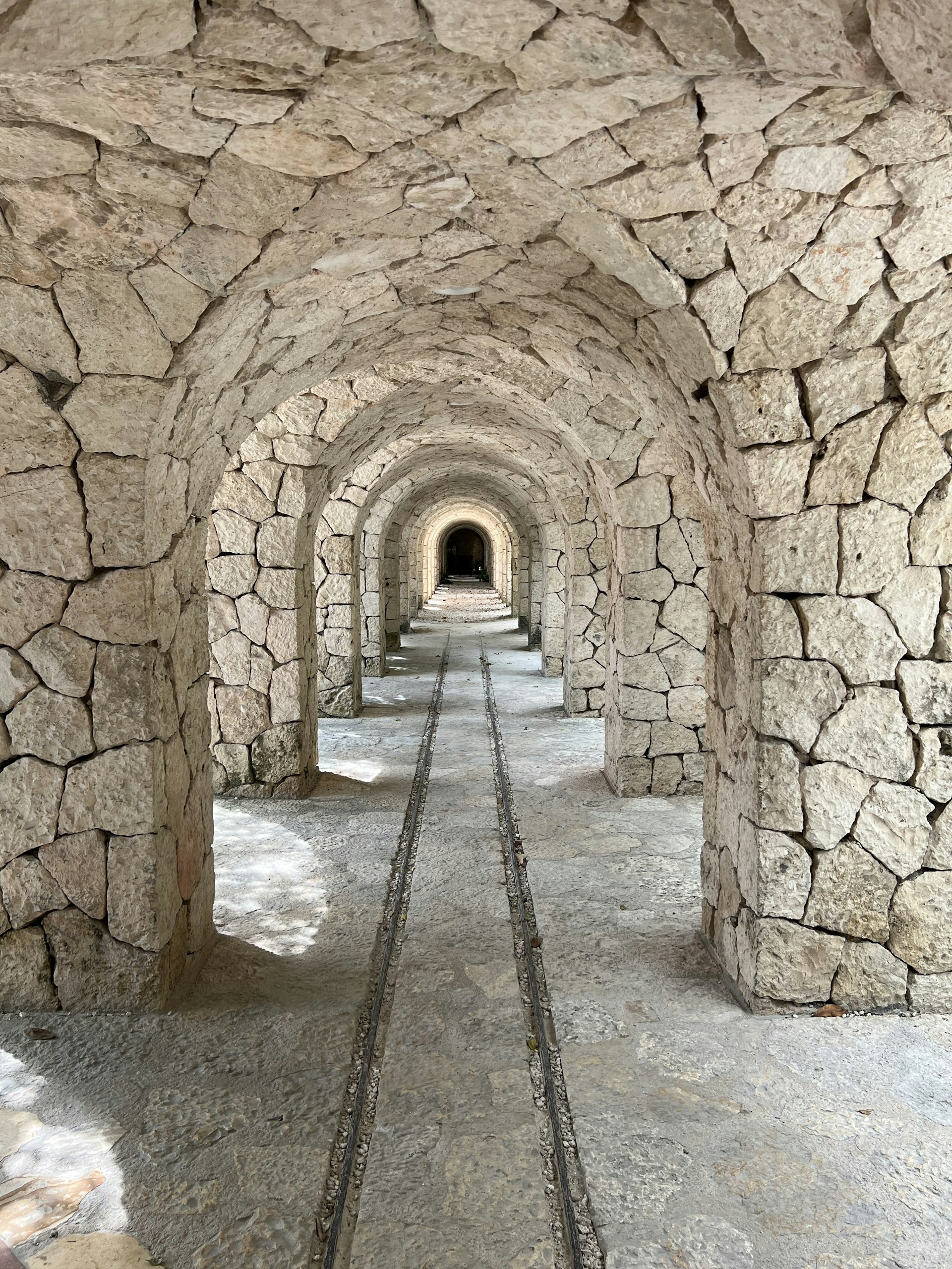 a tunnel with a train track going through it