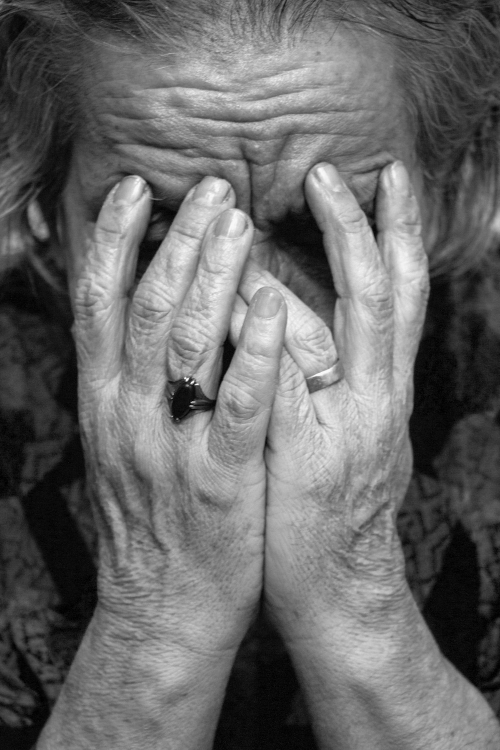 a woman covering her face with her hands