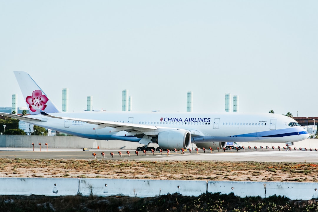a china airlines plane on the runway at an airport,