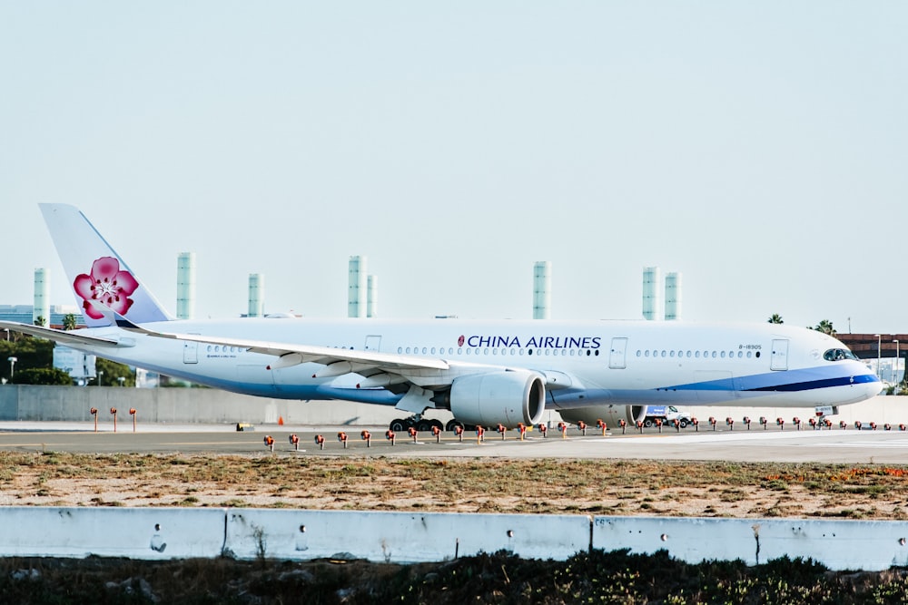 a china airlines plane on the runway at an airport