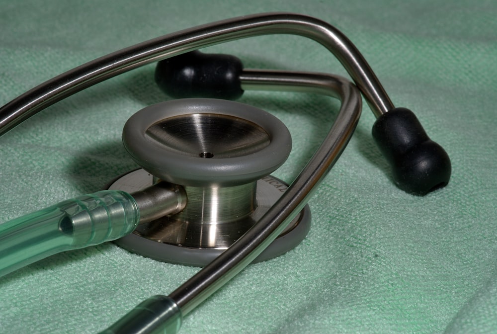 a stethoscope laying on top of a green blanket