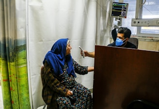 a woman in a blue scarf sitting on a chair