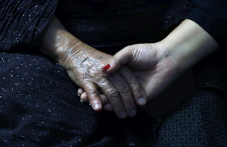 a woman's hands with red nail polish on them