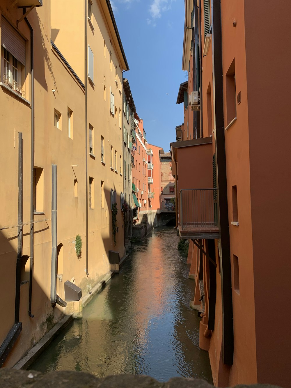 a narrow river running between two buildings in a city