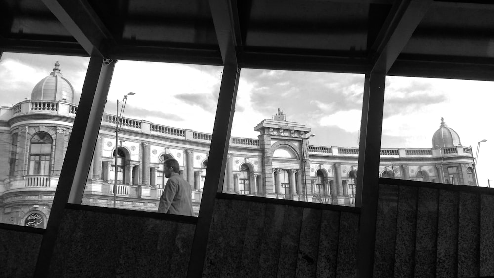 a black and white photo of a building through a window