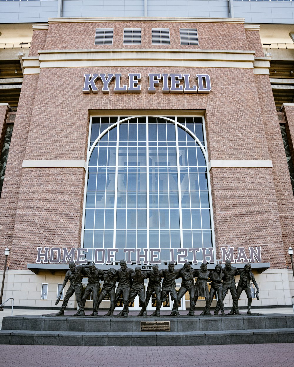 a statue of a group of men in front of a building