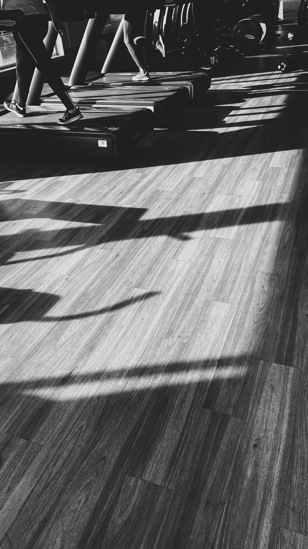 a group of people riding skateboards down a wooden floor