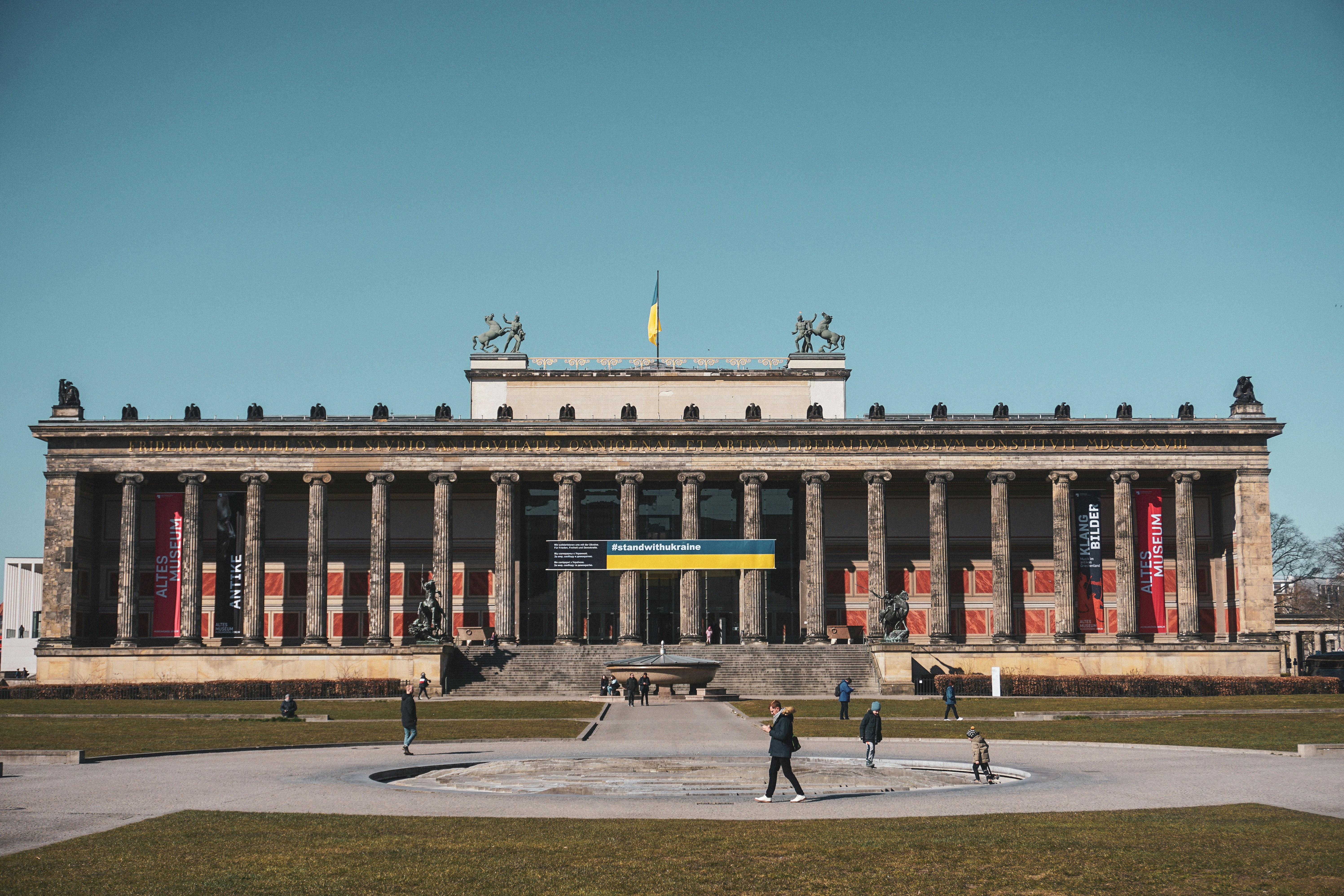 a large building with a fountain in front of it