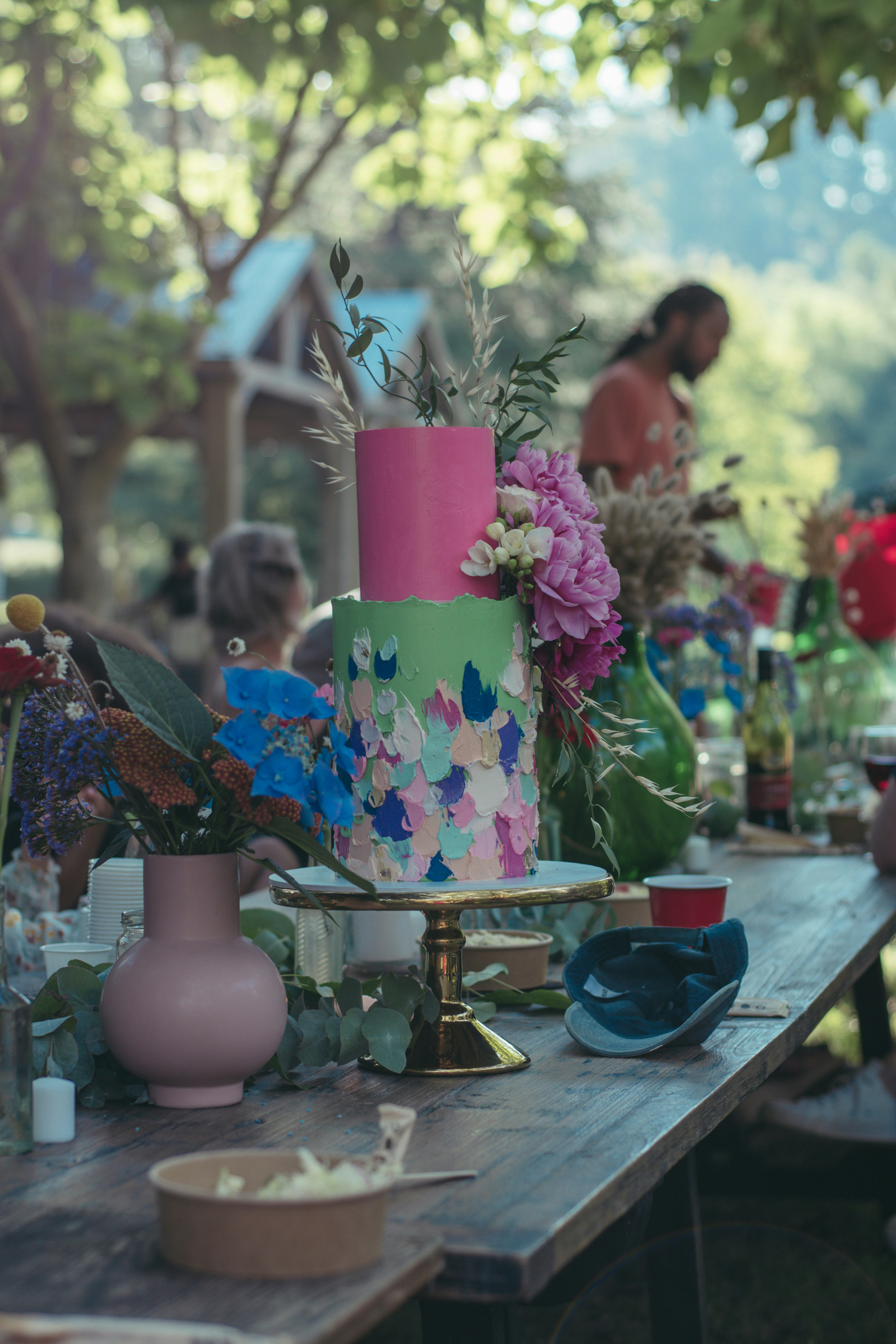 a table topped with a multi colored cake