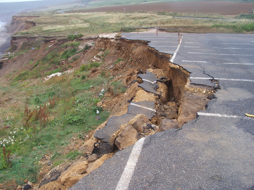 a large crack in the side of a road