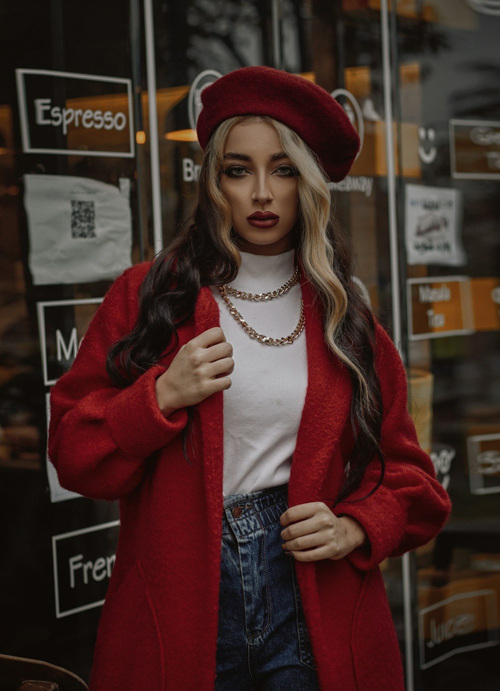 a woman wearing a red coat and hat