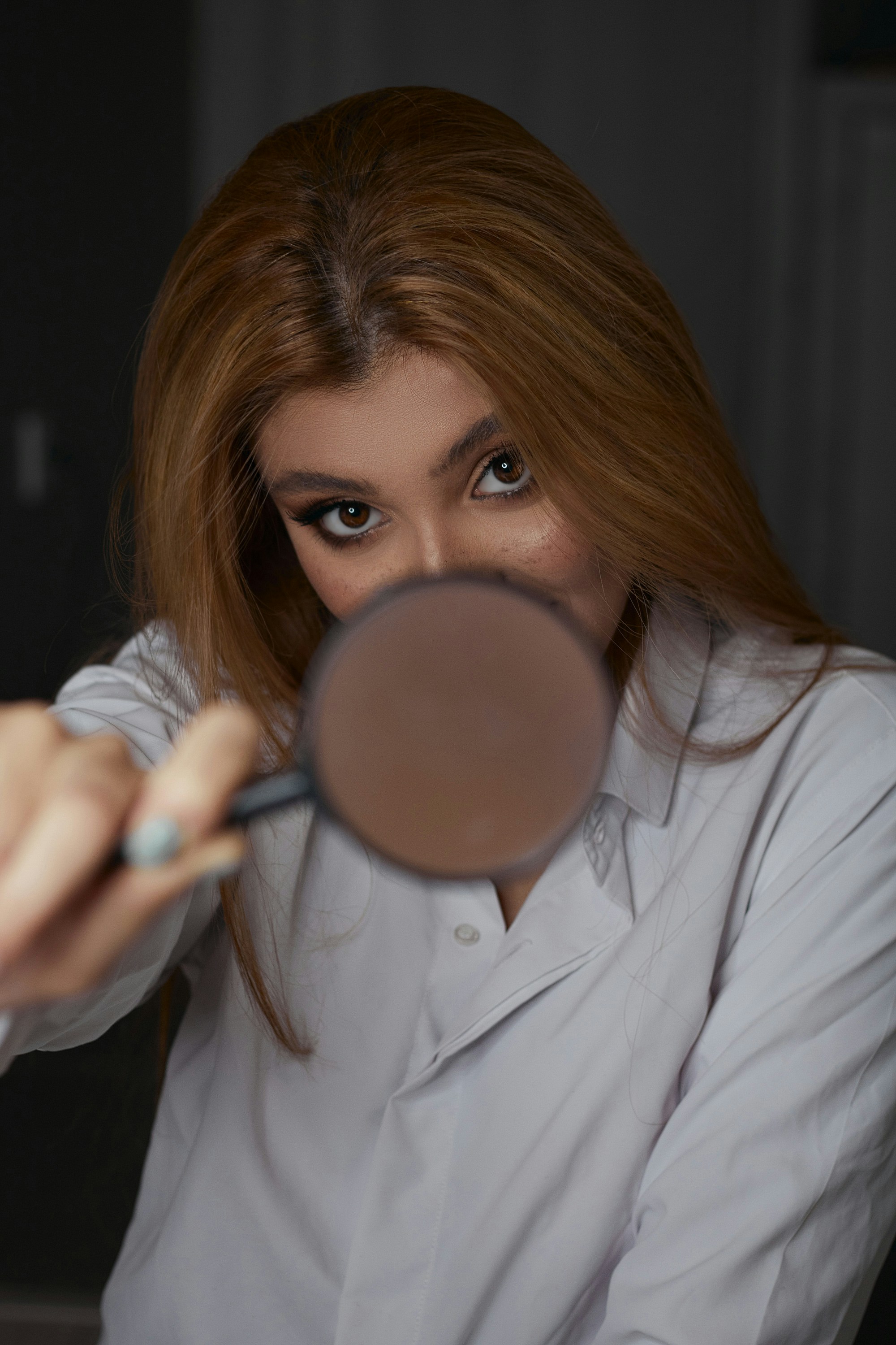 a woman looking through a magnifying glass