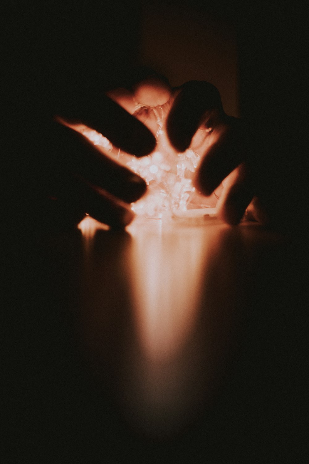 a person holding a lit object in their hands