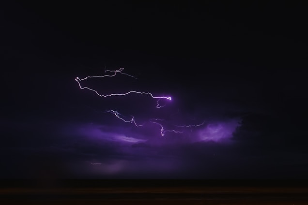 A dynamic RPG battlefield illuminated by a swirling storm overhead, highlighting characters in action.