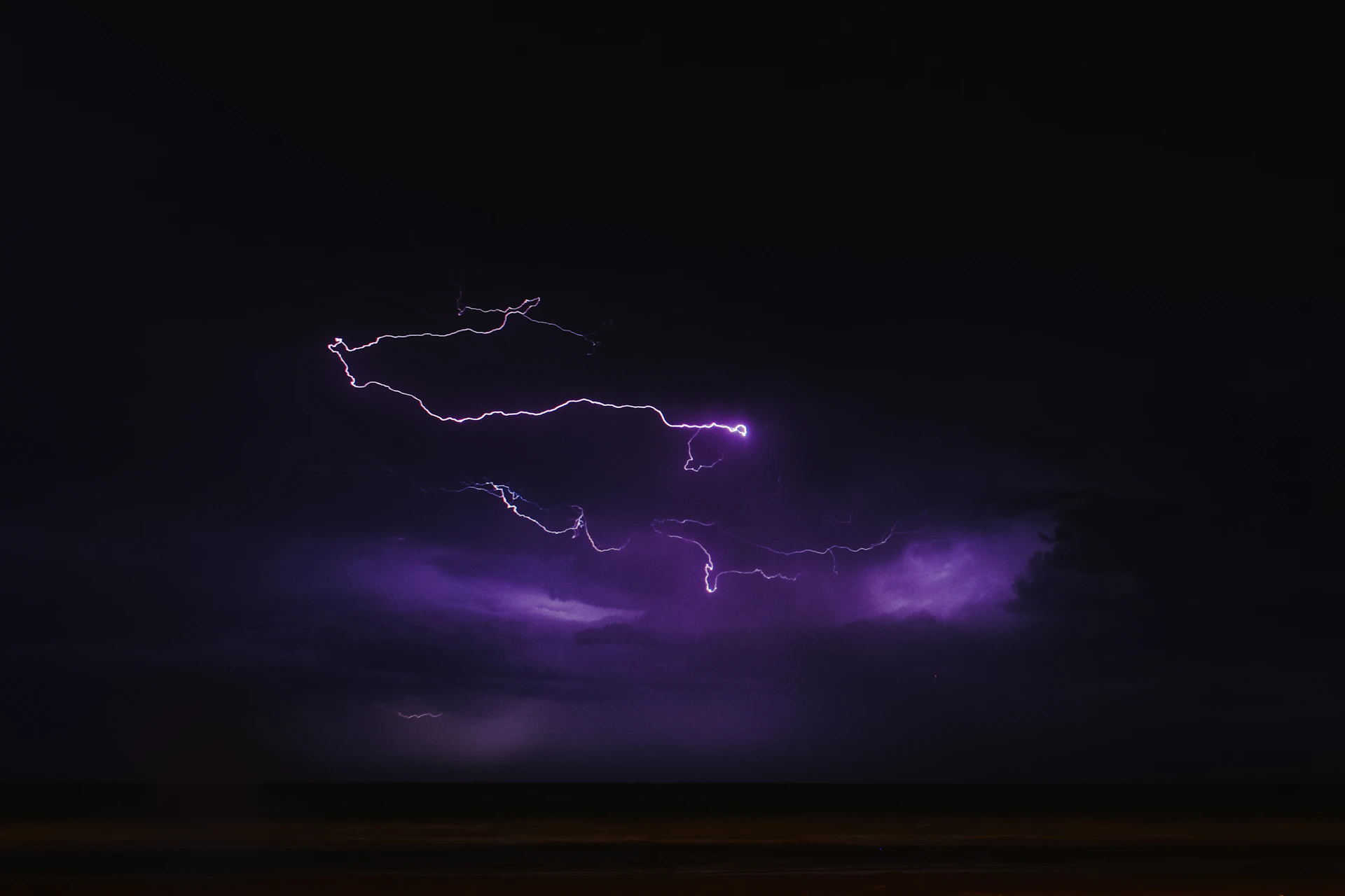 A dynamic shot of adipr swirling with fierce wind and sparks flying from its sharp sword under a stormy sky.