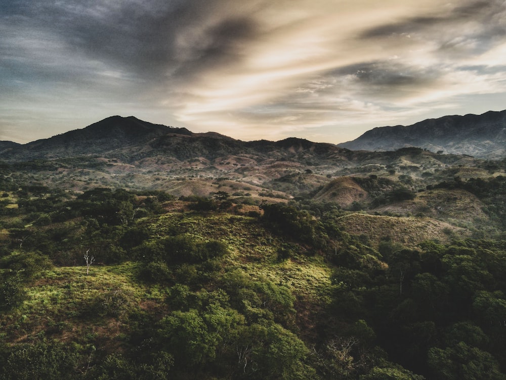 a view of a mountain range with a cloudy sky