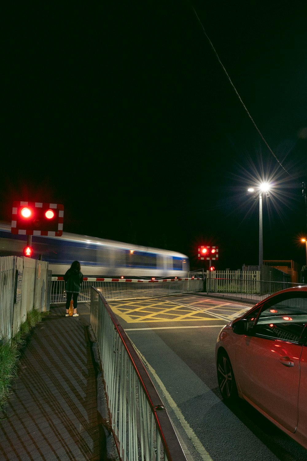 a car stopped at a red light at night