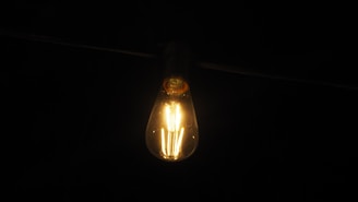a light bulb is glowing in the dark