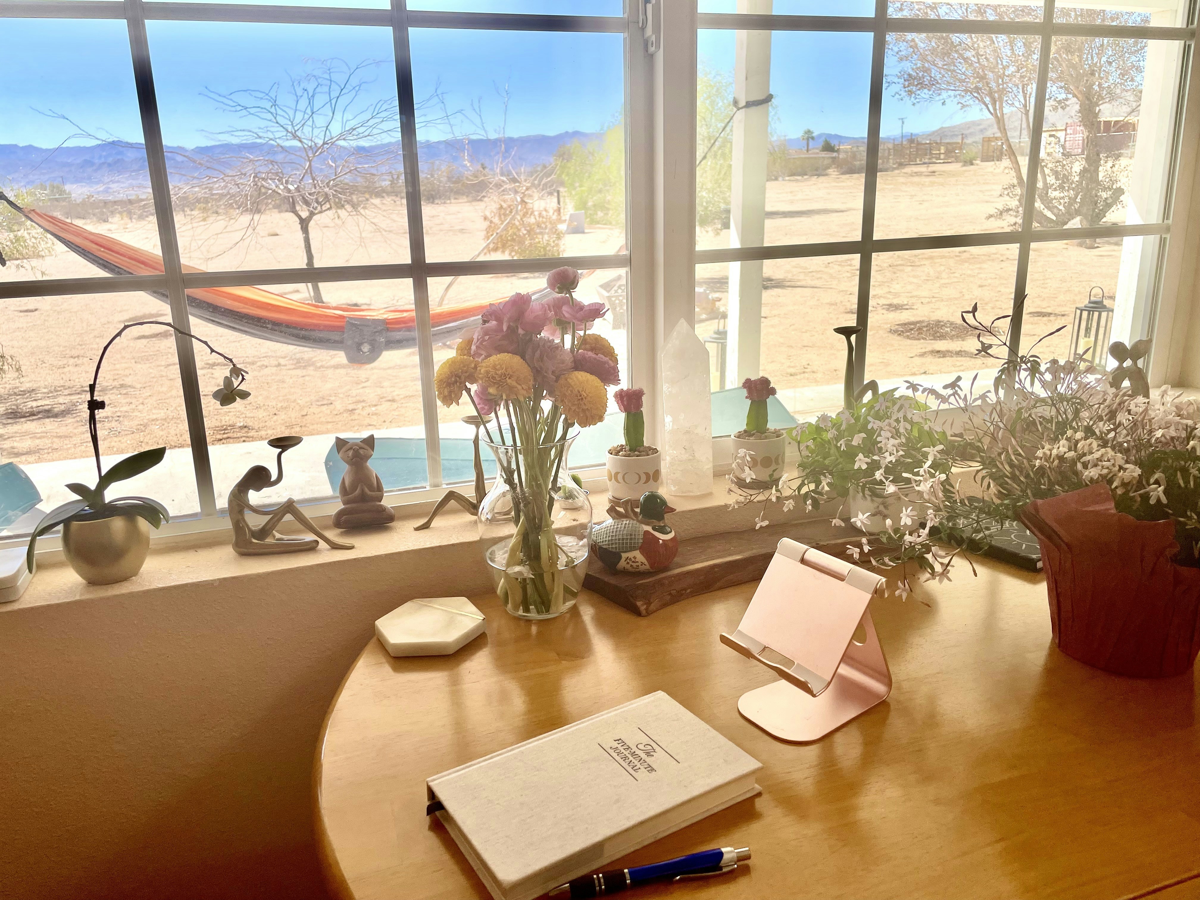 Coastal office space with book and flowers