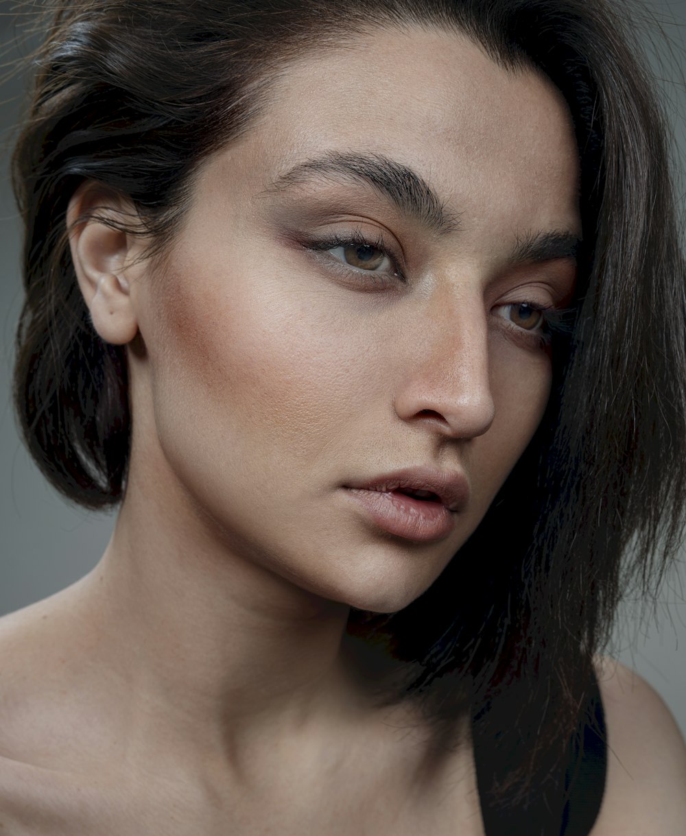 a close up of a woman with dark hair