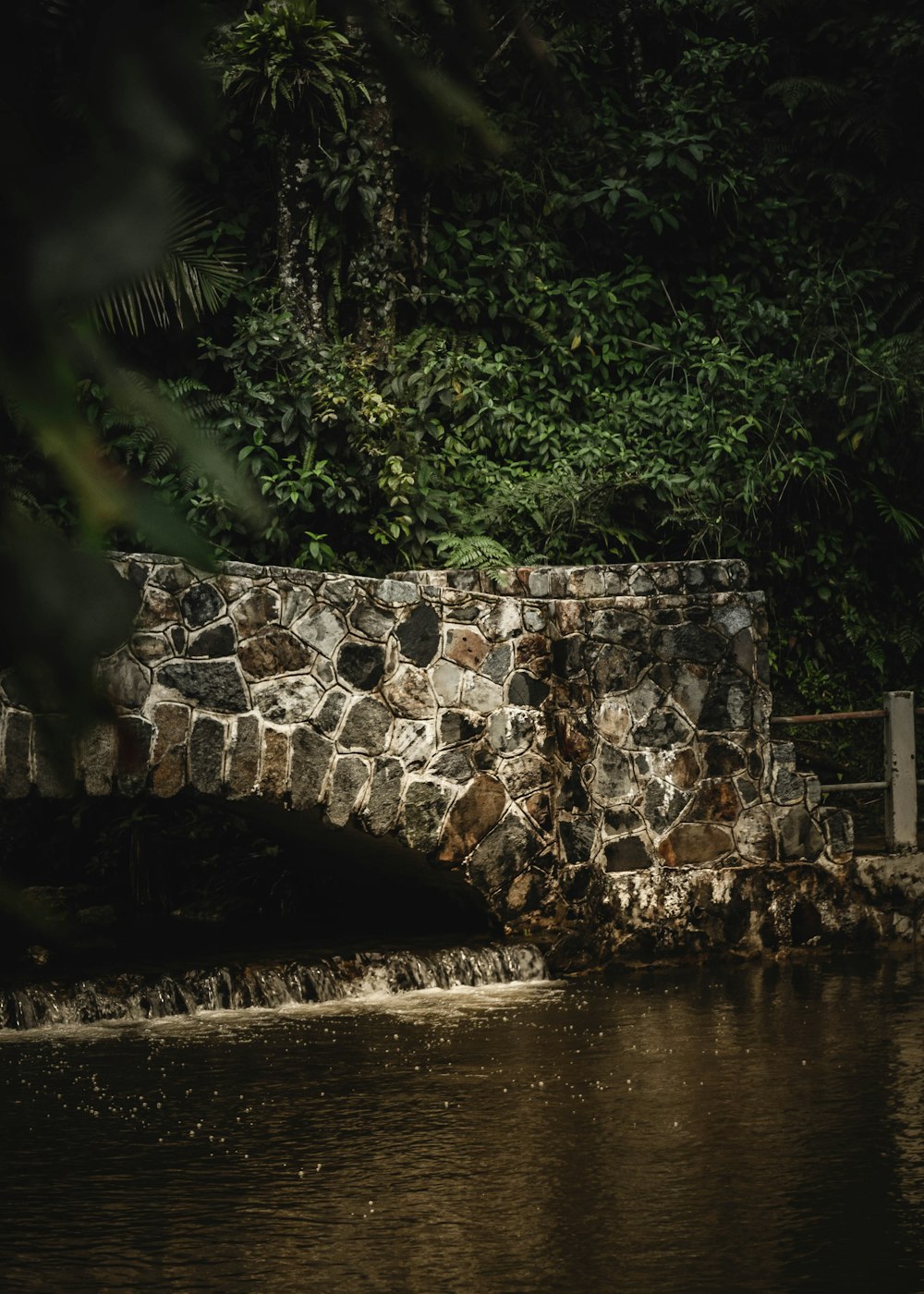 a stone bridge over a body of water