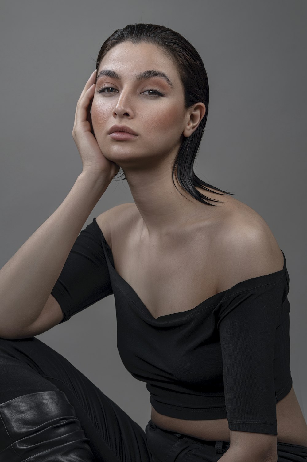 a woman in a black top is posing for a picture