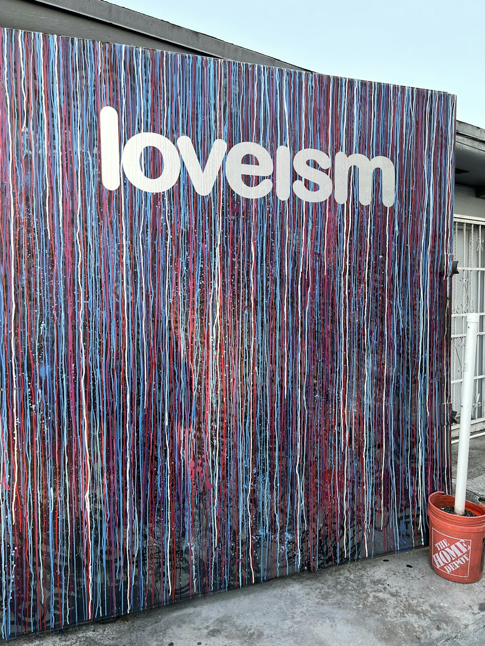 a wall that has a sign that says loveism on it