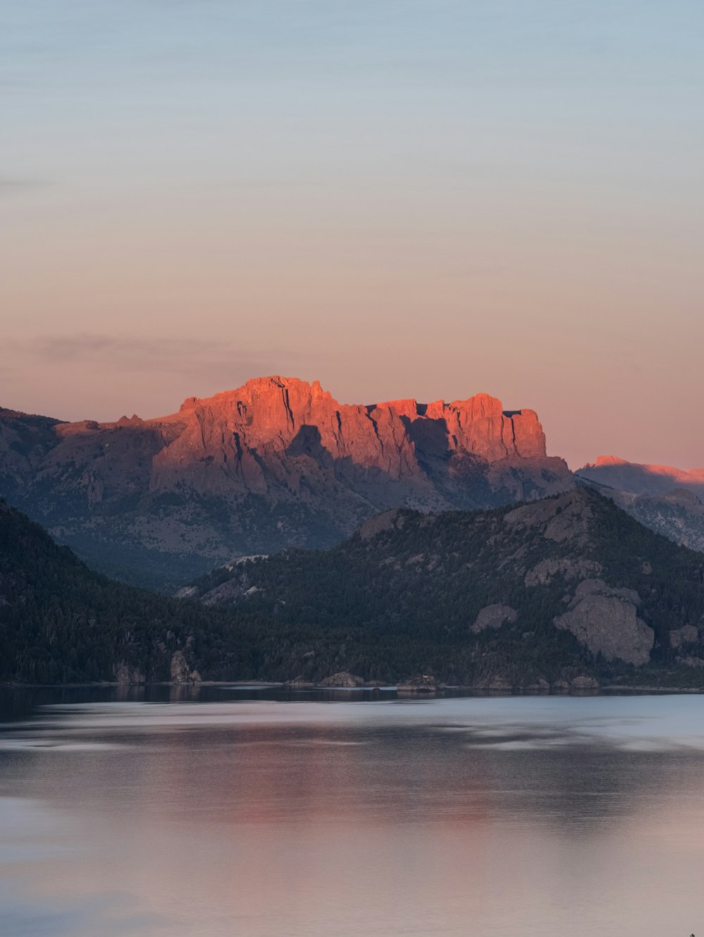 a large body of water with mountains in the background