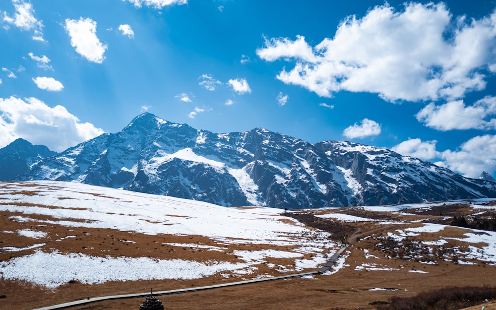 a snow covered mountain with a road going through it