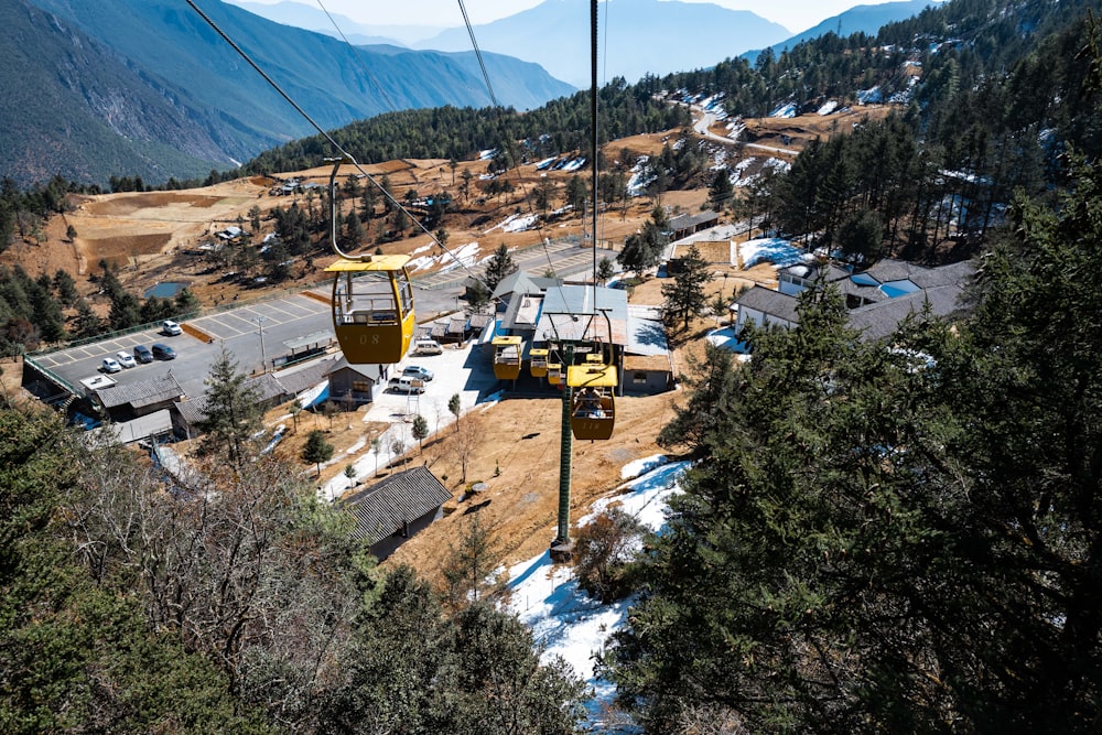 a yellow ski lift going up a hill