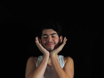 a man with his hands on his face