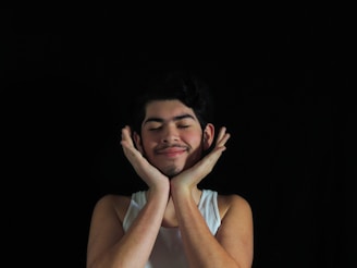 a man with his hands on his face