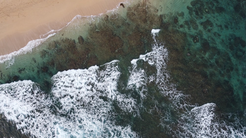 an aerial view of a sandy beach and ocean