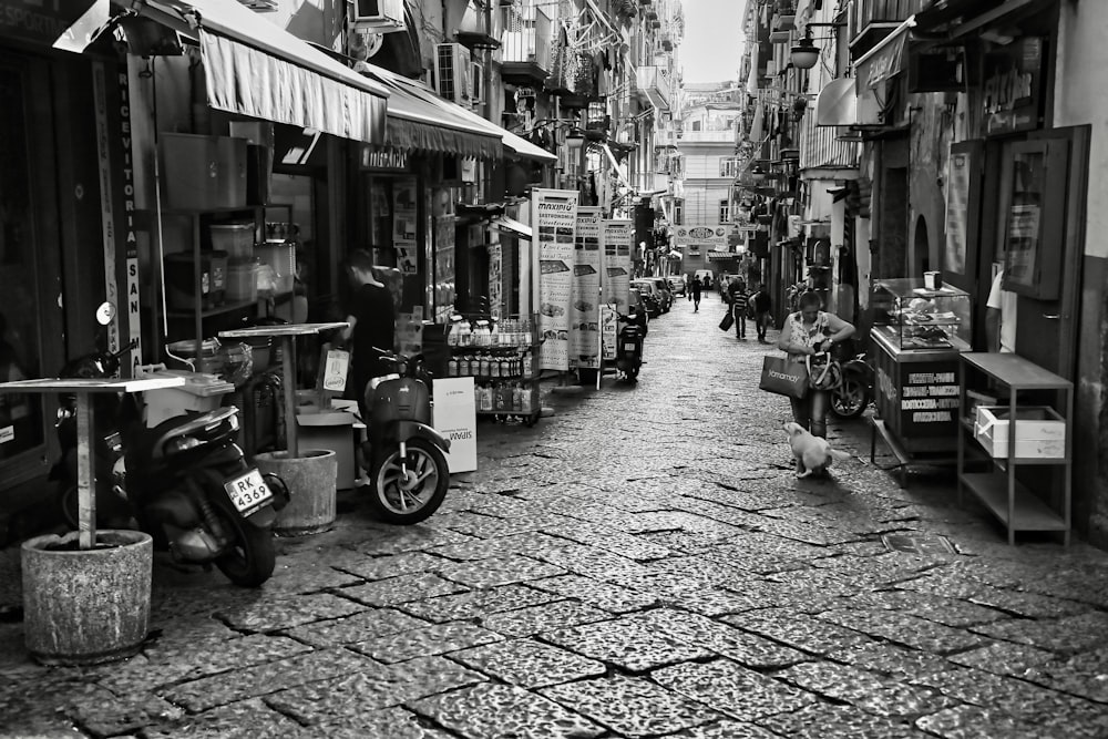 a black and white photo of a narrow street