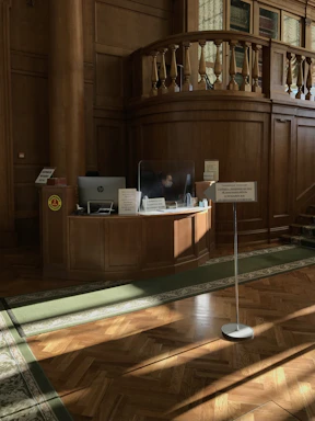 A calm medical office reception with a phone and a computer on the desk.