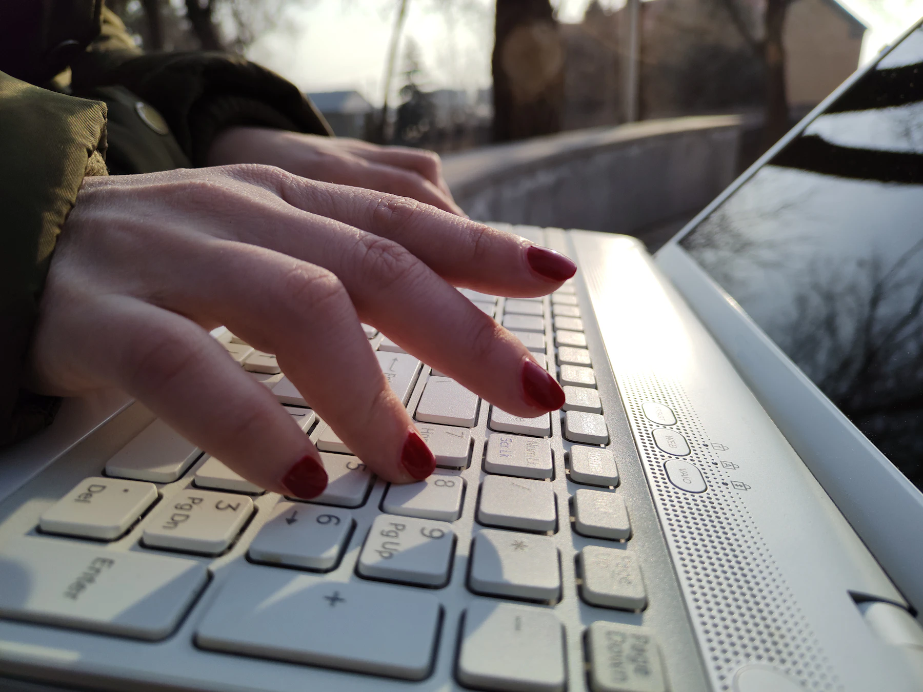Close-up of a person typing on a laptop keyboard