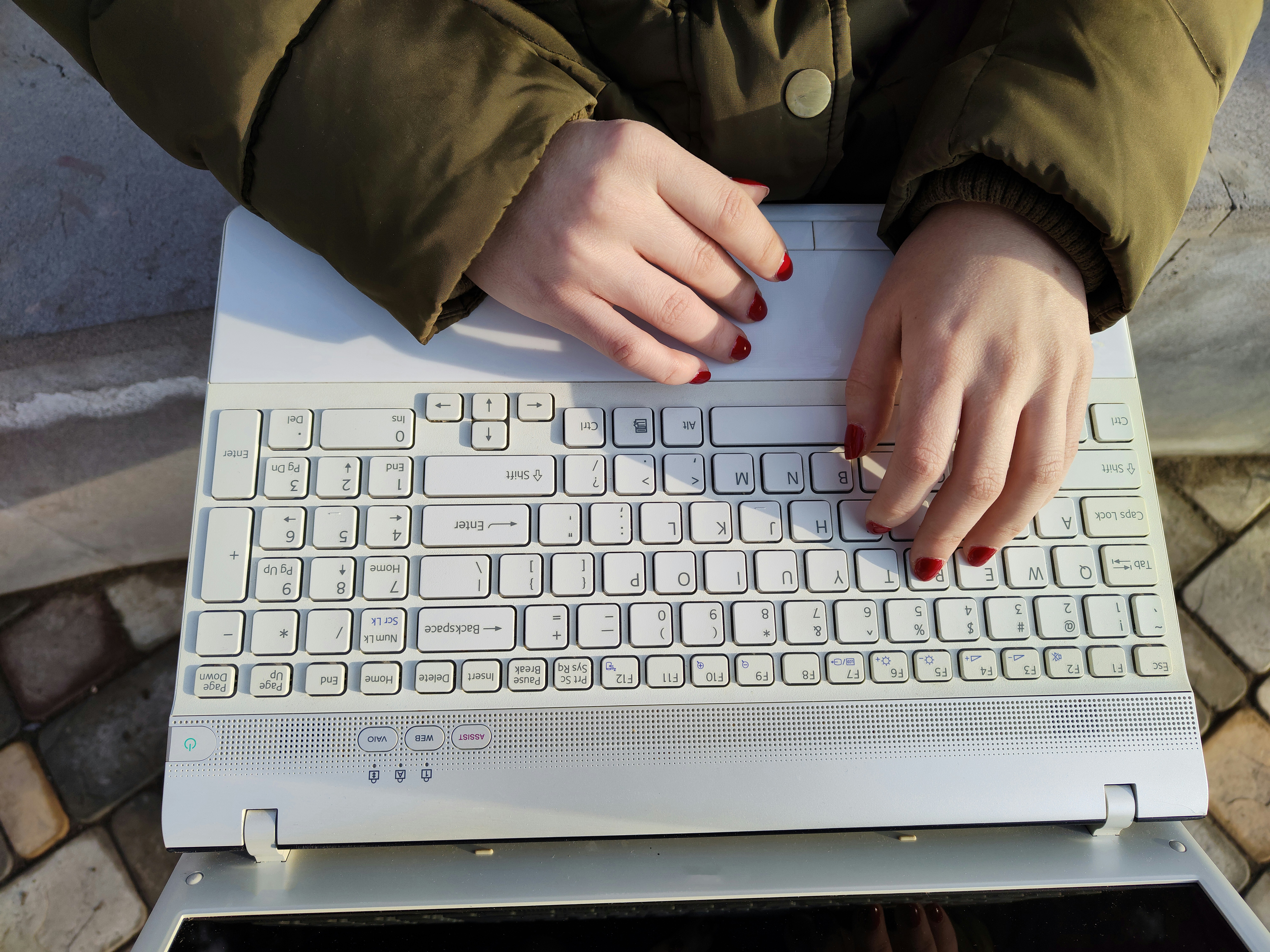 a woman is typing on a computer keyboard