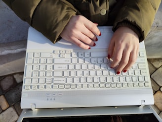 a woman is typing on a computer keyboard