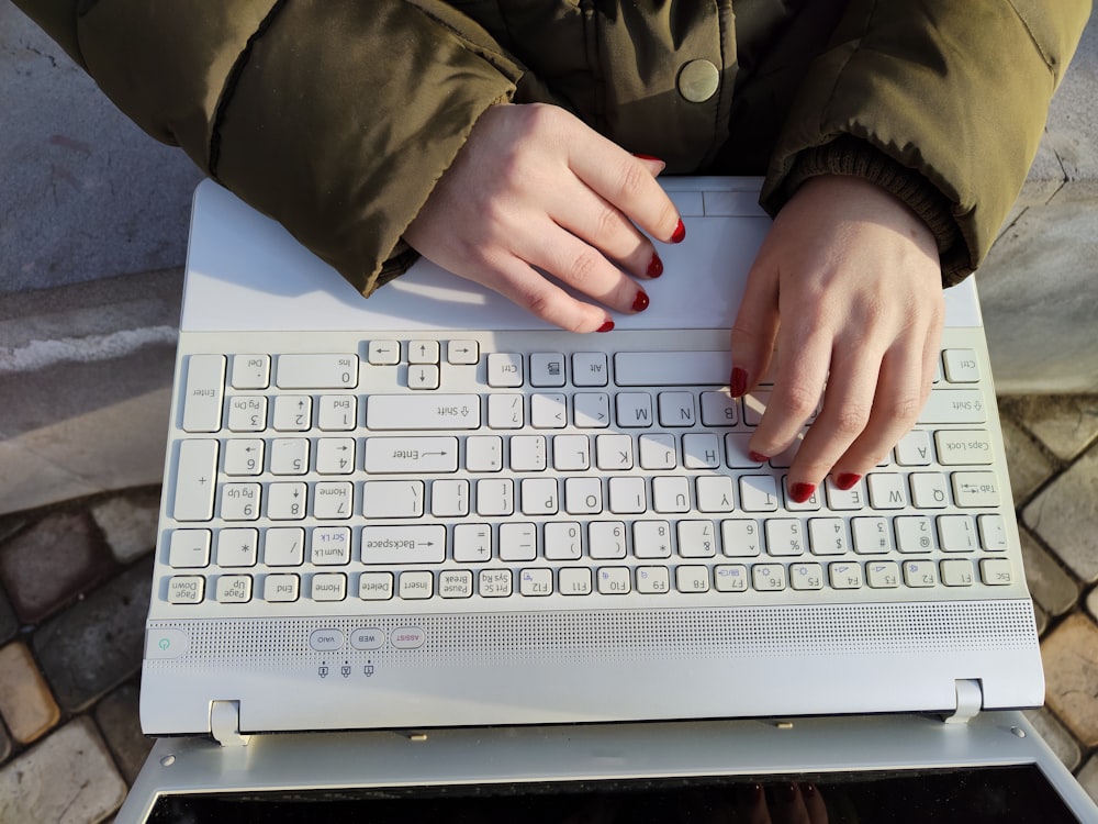 a woman is typing on a computer keyboard