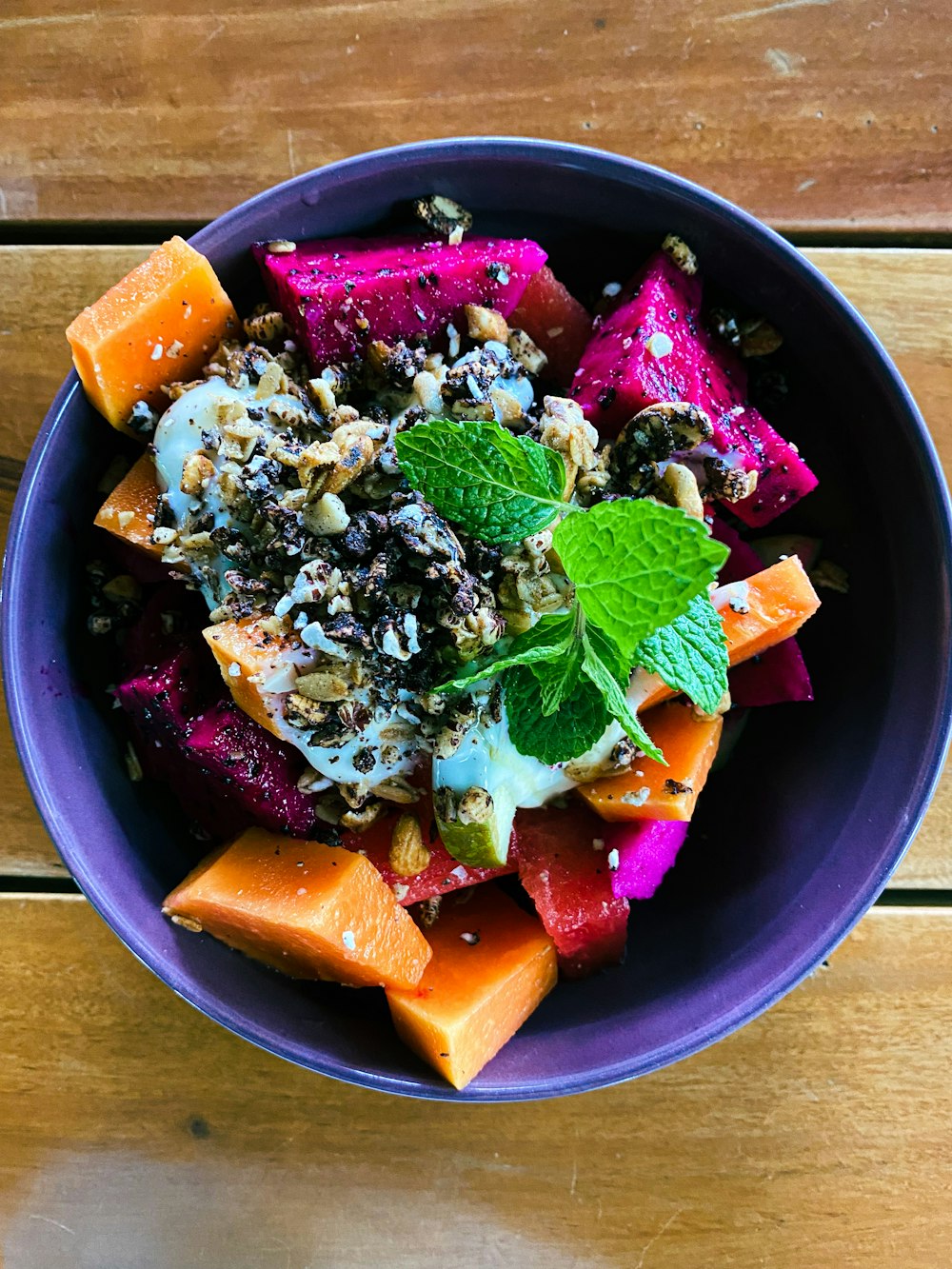 a purple bowl filled with different types of food