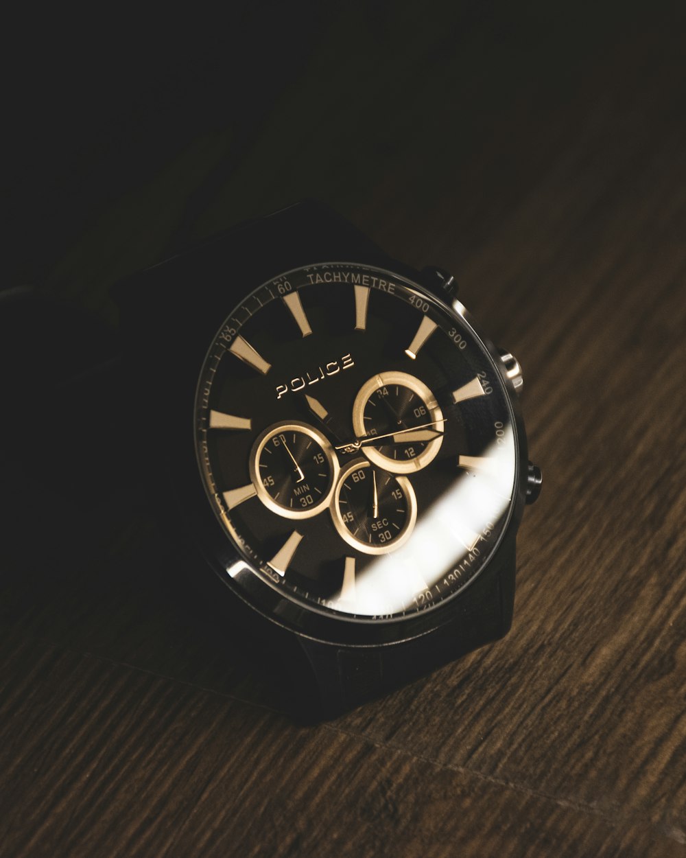 a watch sitting on top of a wooden table