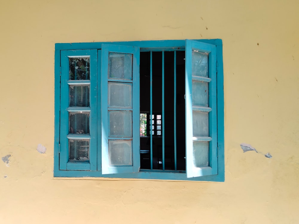 a blue window with bars on the outside of it