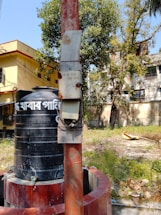 A friendly technician explaining septic tank maintenance to a homeowner outdoors.