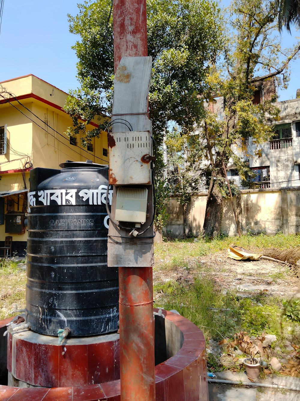 a red and black fire hydrant sitting in front of a building