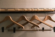 a row of wooden clothes hangers on a wall