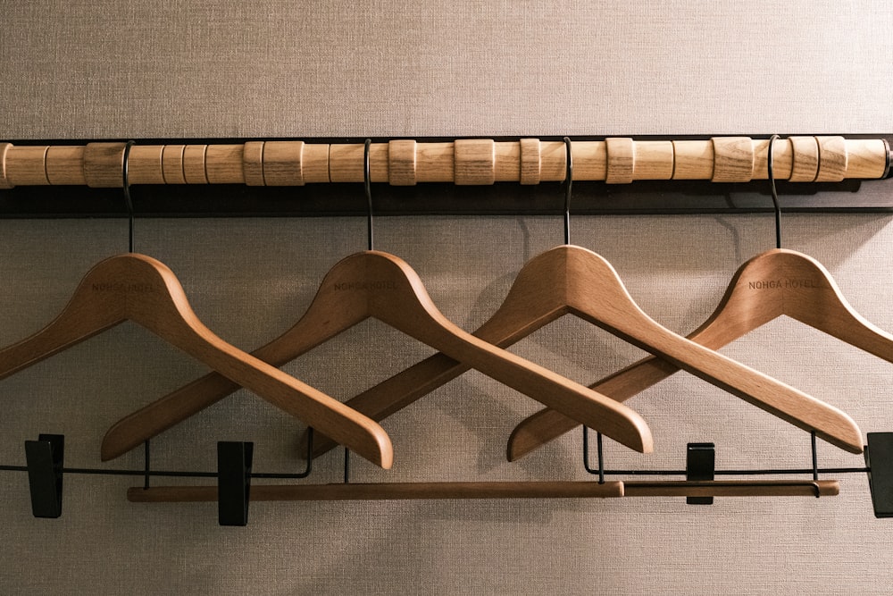 a row of wooden clothes hangers on a wall
