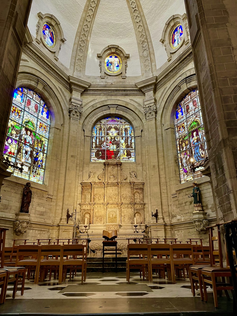 a church with stained glass windows and pews