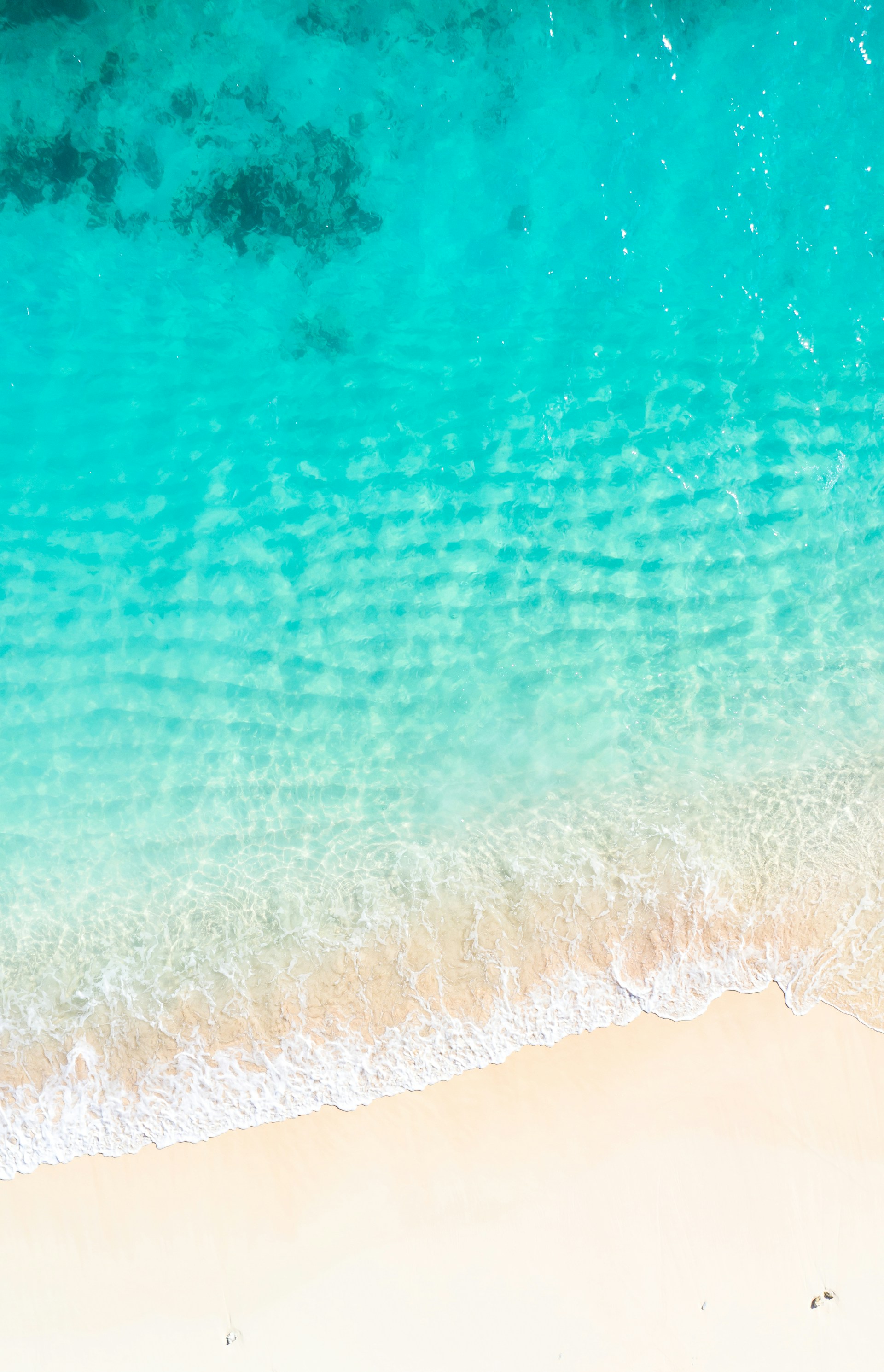 an aerial view of a sandy beach and ocean