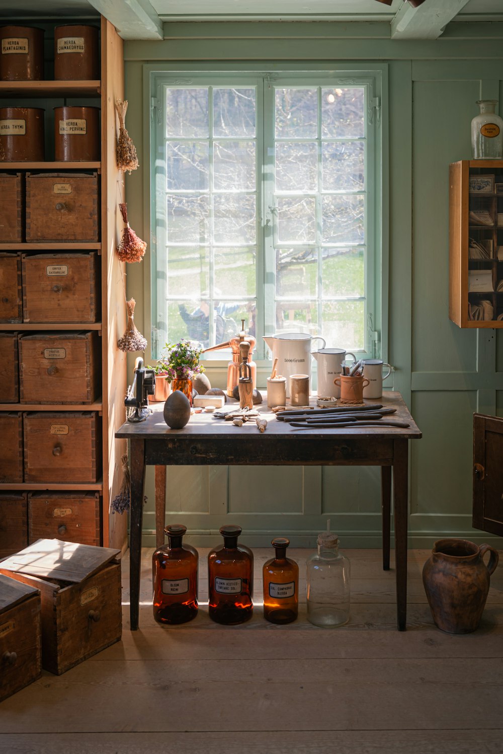 a table in a room with a bunch of jars on it